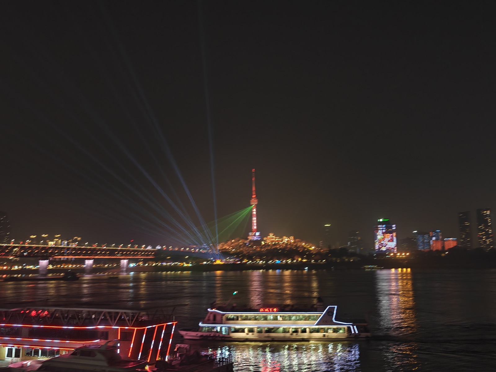Laser show over the Yangtze at night, seen from the Wuhan riverfront